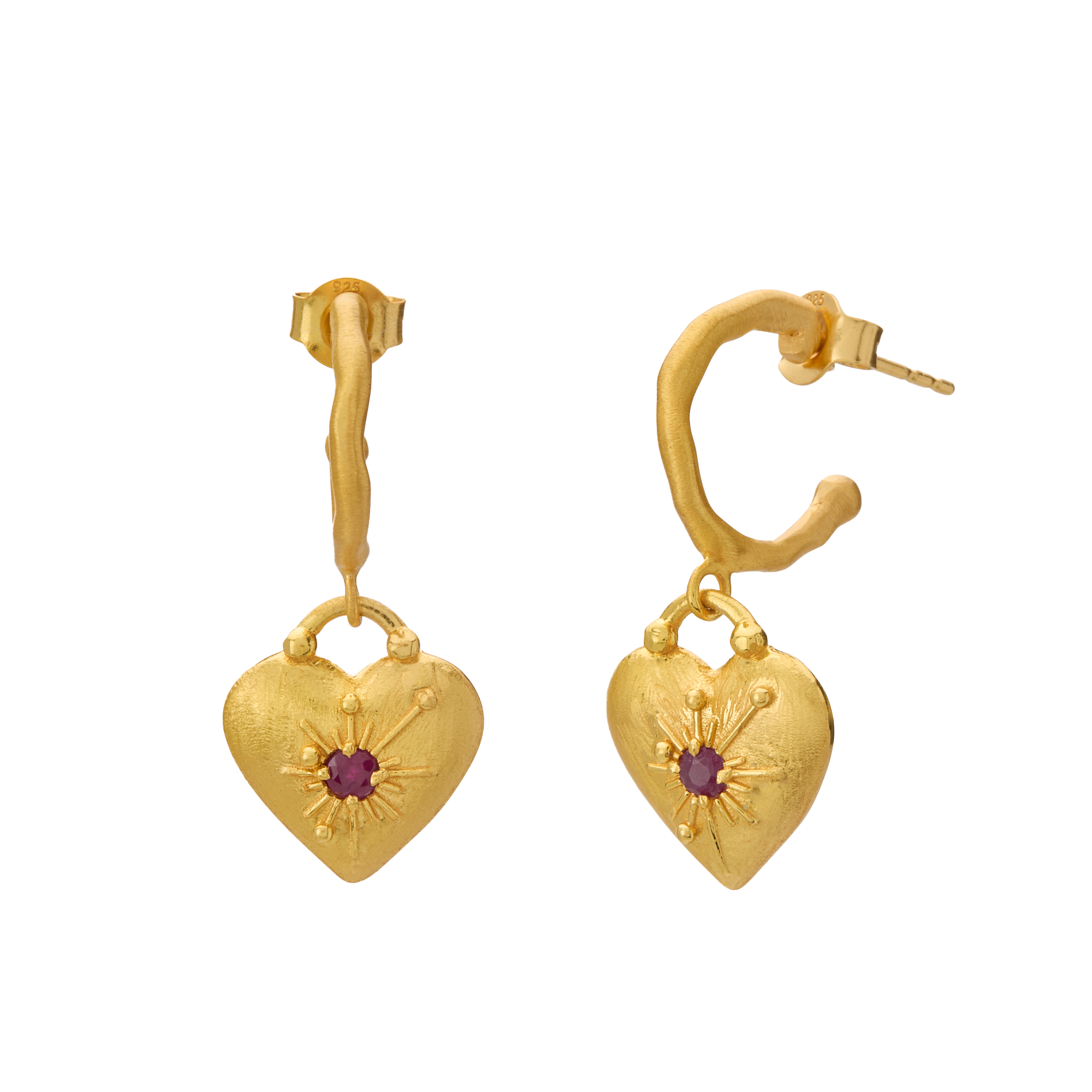 Gold heart-shaped earrings with a central red gemstone on a white background